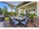 Stylish outdoor dining space with a large table, seating for eight, and lush landscaping, creating a perfect ambiance at 14480 Eagle Branch Dr, Nokomis, FL 34275