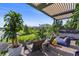Relaxing outdoor seating area with lounge chairs, lush plants, and a luxurious hot tub, creating a serene escape at 14480 Eagle Branch Dr, Nokomis, FL 34275