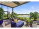 Picturesque patio with lounge seating, vibrant plants, and a calming lake view, offering an inviting outdoor space at 14480 Eagle Branch Dr, Nokomis, FL 34275