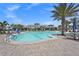 Large community pool with plenty of seating and palm trees to provide shade at 14480 Eagle Branch Dr, Nokomis, FL 34275