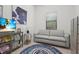 Comfortable sitting room featuring a gray sofa, mounted TV, and area rug at 14480 Eagle Branch Dr, Nokomis, FL 34275