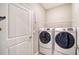 Laundry room featuring a modern washer and dryer and wire shelving at 16633 Mooner Plank Cir, Wimauma, FL 33598