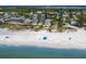 Stunning aerial view of beachfront homes and sandy beach, with lush greenery, and ocean view at 3007 Avenue F # 1, Holmes Beach, FL 34217