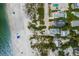 Aerial view showcasing the proximity to the beach, with lush greenery, swimming pools, and upscale community at 3007 Avenue F # 1, Bradenton Beach, FL 34217