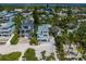 Aerial view of an elegant coastal home surrounded by lush greenery, showcasing its prime location near the beach at 3007 Avenue F # 1, Holmes Beach, FL 34217