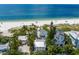 Stunning aerial view showcasing oceanfront homes and lush vegetation, capturing the essence of luxurious beachfront living at 3007 Avenue F # 1, Holmes Beach, FL 34217
