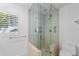 Modern tiled shower with glass enclosure and tiled flooring at 3007 Avenue F # 1, Holmes Beach, FL 34217