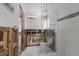 Bathroom featuring a glass shower, toilet, and exposed walls in the middle of remodeling at 3007 Avenue F # 1, Holmes Beach, FL 34217