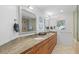 Bathroom features double sinks with granite countertops, large mirrors, and a shower at 3007 Avenue F # 1, Holmes Beach, FL 34217