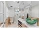 Bright bathroom featuring a glass-enclosed shower, vessel sinks, and modern fixtures, all with a clean, white aesthetic at 3007 Avenue F # 1, Holmes Beach, FL 34217