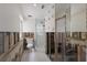 Bathroom featuring a glass shower, toilet, and exposed walls in the middle of remodeling at 3007 Avenue F # 1, Holmes Beach, FL 34217