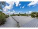 Beach access showing vegetation on path to private beach at 3007 Avenue F # 1, Bradenton Beach, FL 34217