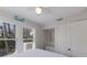Bright bedroom with ample natural light, white bedding, and built-in closet at 3007 Avenue F # 1, Holmes Beach, FL 34217