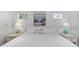 Bedroom features a king-size bed, beach-themed decor, and natural light at 3007 Avenue F # 1, Holmes Beach, FL 34217