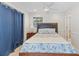 Serene bedroom with ceiling fan, paneled wall, window and stylish bedding with beach-themed colors at 3007 Avenue F # 1, Holmes Beach, FL 34217