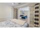 Charming bedroom with connecting view to a living space with white planked walls, doors, and stylish decor at 3007 Avenue F # 1, Holmes Beach, FL 34217