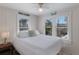 Comfortable bedroom with white bedding, bright windows, and beach-themed decorations at 3007 Avenue F # 1, Holmes Beach, FL 34217