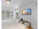Bedroom with balcony access, flat-screen TV, and beach view art at 3007 Avenue F # 1, Holmes Beach, FL 34217