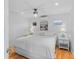 Cozy bedroom with a king-size bed, ceiling fan, and beach-themed decor at 3007 Avenue F # 1, Holmes Beach, FL 34217