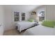 Comfortable bedroom with twin beds, bright windows, and neutral decor at 3007 Avenue F # 1, Holmes Beach, FL 34217