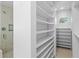 Walk-in closet features built-in shelving and a shower area at 3007 Avenue F # 1, Holmes Beach, FL 34217