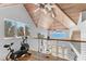 Bright upstairs area with wood ceiling, an exercise bike, and views of ocean at 3007 Avenue F # 1, Holmes Beach, FL 34217
