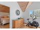 Bright upstairs area with wood ceiling, an exercise bike, and views of ocean at 3007 Avenue F # 1, Holmes Beach, FL 34217