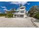 Beautiful beach house with a light exterior, spacious balcony, and beachfront access at 3007 Avenue F # 1, Holmes Beach, FL 34217