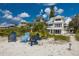 Charming beach house featuring a multi-level deck, elegant railing, and beachside charm at 3007 Avenue F # 1, Holmes Beach, FL 34217