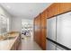 Kitchen featuring wood cabinets, stainless steel refrigerator and a view to the living room with ocean views at 3007 Avenue F # 1, Holmes Beach, FL 34217