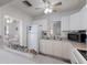 Well-lit kitchen with white appliances and cabinetry, open to the living area for easy entertaining at 3007 Avenue F # 1, Holmes Beach, FL 34217