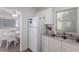 Kitchen with white appliances and cabinetry, conveniently situated near the dining area at 3007 Avenue F # 1, Holmes Beach, FL 34217