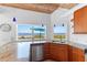Kitchen featuring granite counters, stainless appliances, and beach view at 3007 Avenue F # 1, Holmes Beach, FL 34217