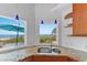 Kitchen sink featuring granite counters, stainless appliances, and beach view at 3007 Avenue F # 1, Holmes Beach, FL 34217