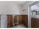 Laundry room in the middle of remodeling with exposed framing and a window with outside view at 3007 Avenue F # 1, Bradenton Beach, FL 34217
