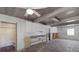 Open-concept living room with lovely tile floors, wood ceilings and a bright open window at 3007 Avenue F # 1, Holmes Beach, FL 34217