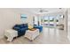 Cozy living room with plank walls, French doors to the outside, and comfortable seating area with plush blue couch at 3007 Avenue F # 1, Holmes Beach, FL 34217