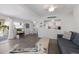 Inviting living room with open layout to kitchen and dining area, featuring a TV and comfortable seating at 3007 Avenue F # 1, Holmes Beach, FL 34217