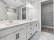 Bathroom with double sink vanity and white marble flooring, adjacent to the closet at 3118 Tramonto Ct, Bradenton, FL 34211