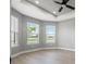 Bedroom with recessed ceiling and fan plus view of the lake out the windows at 3118 Tramonto Ct, Bradenton, FL 34211