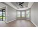 A flexible space with ceiling fan and windows facing the lake at 3118 Tramonto Ct, Bradenton, FL 34211