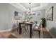 Dining room boasts modern chandelier, contemporary art and area rug with a calming aesthetic at 3118 Tramonto Ct, Bradenton, FL 34211