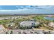 Expansive aerial view showcasing a community building with golf course, lakes, and other amenities at 3118 Tramonto Ct, Bradenton, FL 34211