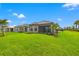 Back exterior showing the screened porch and view of the yard and neighborhood at 3118 Tramonto Ct, Bradenton, FL 34211