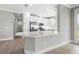Bright, open kitchen with white cabinetry, modern stainless steel appliances, and a peninsula counter at 3118 Tramonto Ct, Bradenton, FL 34211