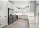 Well-lit kitchen featuring white cabinets, stainless steel appliances, and a window overlooking greenery at 3118 Tramonto Ct, Bradenton, FL 34211