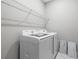 Well-lit laundry room equipped with a Samsung washer and dryer, and a wire shelf for storage at 3118 Tramonto Ct, Bradenton, FL 34211