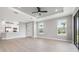 Open-concept living room with wood floors, a tray ceiling and connected to the kitchen at 3118 Tramonto Ct, Bradenton, FL 34211