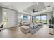 Bright living room featuring modern furniture, light wood floors, and a large window with beautiful views at 3118 Tramonto Ct, Bradenton, FL 34211