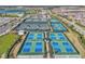 Aerial view of the community's new pickleball courts and clubhouse surrounded by landscaping and parking at 3118 Tramonto Ct, Bradenton, FL 34211